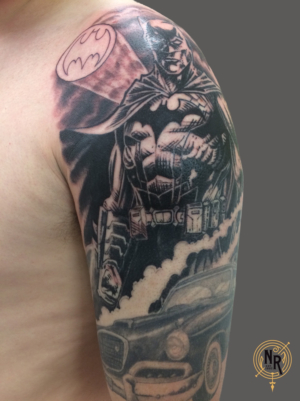 Batman comic-style shoulder tattoo